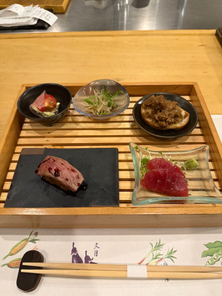木箱に並んだ和牛の握りと前菜四種盛り